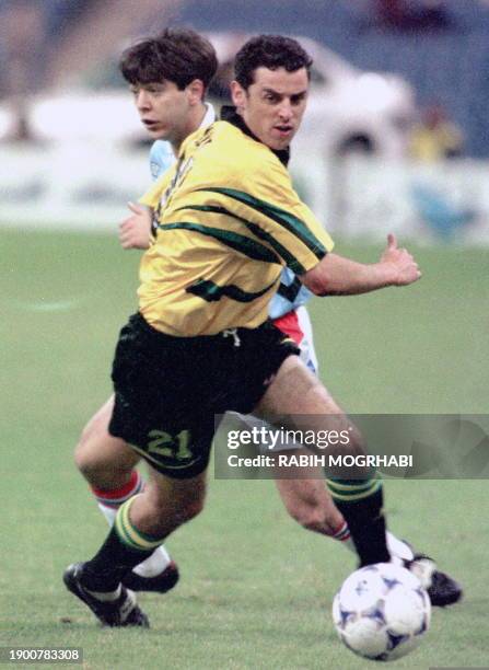 Australian forward Kevin Muscat fights for the ball with Uruguayan back Alvaro Recoba 19 December in Riyadh in a FIFA Confederation Cup semi-final...