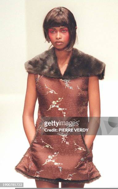 South Korean designer Lee Young Hee showed this brown pouch-pocket mini dress with white and sky blue accents and a furry collar during her 1997/98...