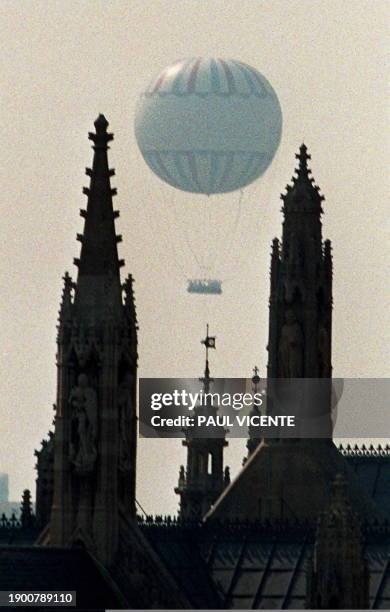 The world's largest tethered passenger helium balloon floats behind the Palace of Westminster home of the British parliament today 08 August, after...