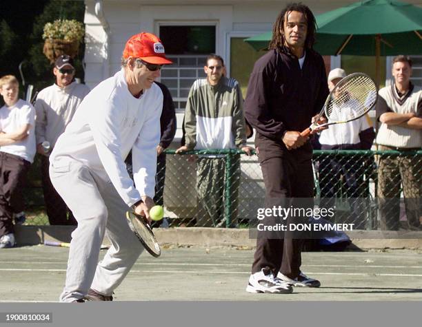 Tennis greats John McEnroe of the US and Yannick Noah of France play exhibition tennis 09 October at the Westchester Country Club in Rye, NY. The two...