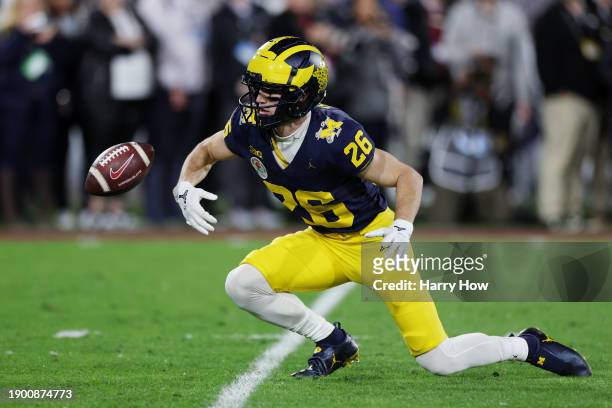 Jake Thaw of the Michigan Wolverines misplays a punt in the fourth quarter against the Alabama Crimson Tide during the CFP Semifinal Rose Bowl Game...