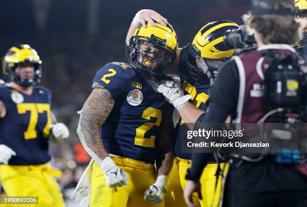 Blake Corum of the Michigan Wolverines celebrates after scoring a touchdown in overtime against the Alabama Crimson Tide during the CFP Semifinal...