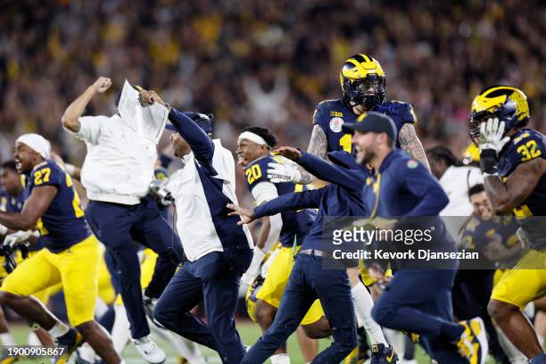 The Michigan Wolverines celebrate after beating the Alabama Crimson Tide 27-20 in overtime during the CFP Semifinal Rose Bowl Game at Rose Bowl...