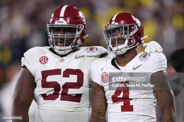 Tyler Booker and Jalen Milroe of the Alabama Crimson Tide react after losing to the Michigan Wolverines 27-20 in overtime during the CFP Semifinal...