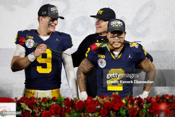 McCarthy and Blake Corum of the Michigan Wolverines celebrate after beating the Alabama Crimson Tide 27-20 in overtime to win the CFP Semifinal Rose...