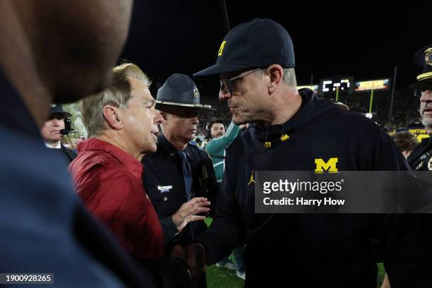 Head coach Nick Saban of the Alabama Crimson Tide and head coach Jim Harbaugh of the Michigan Wolverines meet after the Wolverines beat the Crimson...