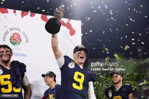 McCarthy of the Michigan Wolverines celebrates with The Leishman Trophy after beating the Alabama Crimson Tide 27-20 in overtime to win the CFP...