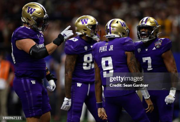 Dillon Johnson of the Washington Huskies celebrates with Michael Penix Jr. #9 after a touchdown during the first quarter against the Texas Longhorns...