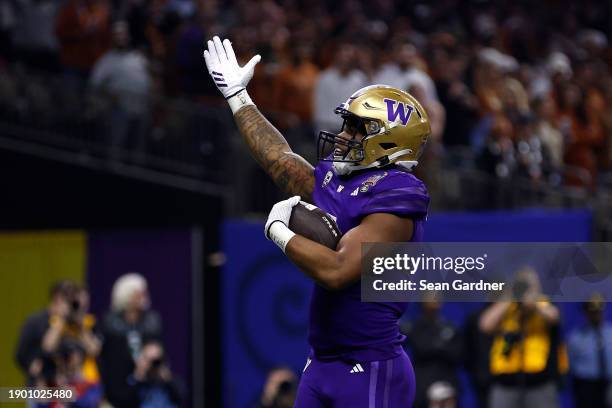 Dillon Johnson of the Washington Huskies celebrates after a touchdown during the second quarter against the Texas Longhorns during the CFP Semifinal...