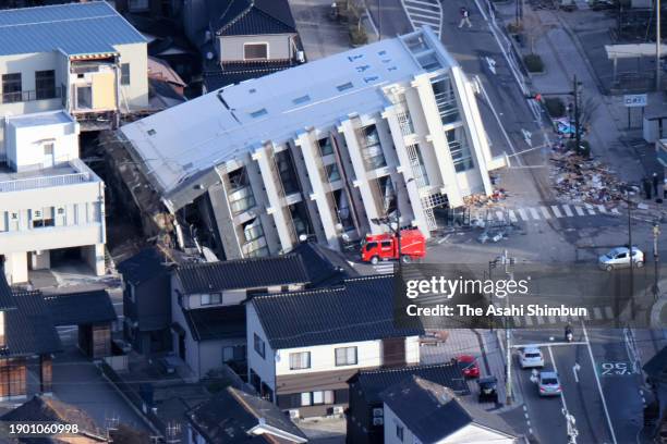 In this aerial image, collapsed building is seen after multiple strong earthquakes hit the area the previous day on January 2, 2024 in Wajima,...