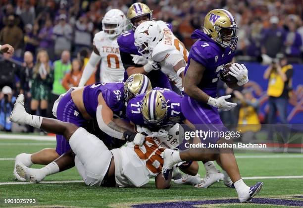 Dillon Johnson of the Washington Huskies rushes for a touchdown during the second quarter against the Texas Longhorns during the CFP Semifinal...