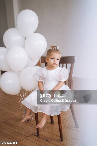 cute little girl of 2 years old in  festive white dress with inflatable balloons on children party in bright room - celebrating 15 years stock pictures, royalty-free photos & images