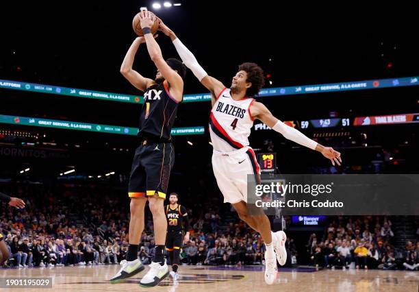 Matisse Thybulle of the Portland Trail Blazers blocks a shot by Devin Booker of the Phoenix Suns during the second half at Footprint Center on...