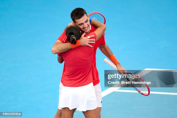 Tomas Barrios Vera and Daniela Seguel of Chile celebrate victory in the Group B doubles match against Maria Sakkari and Stefanos Tsitsipas of Greece...