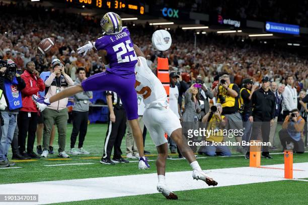 Elijah Jackson of the Washington Huskies breaks up a pass to Adonai Mitchell of the Texas Longhorns on the final play of the CFP Semifinal Allstate...