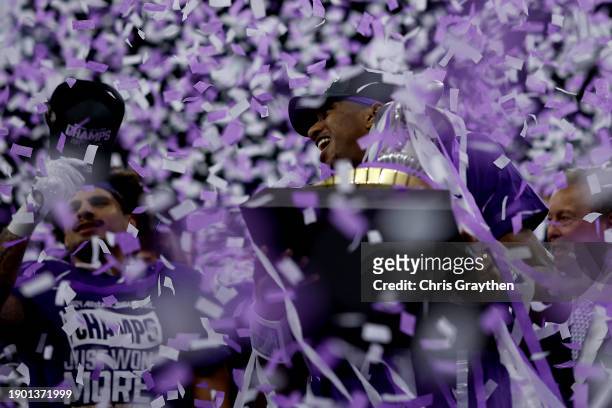 Michael Penix Jr. #9 of the Washington Huskies celebrates with the trophy after a 37-31 victory against the Texas Longhorns in the CFP Semifinal...