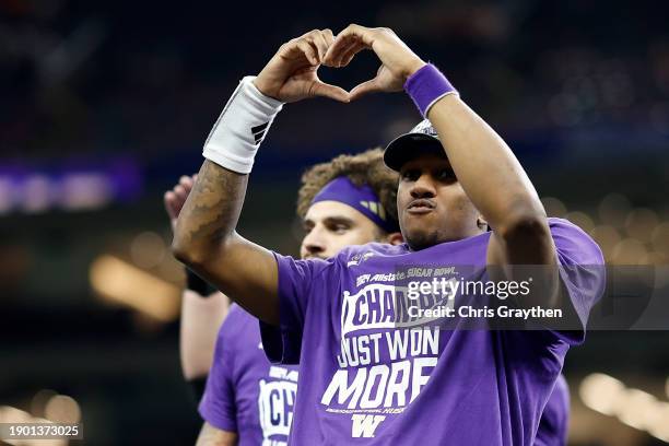 Michael Penix Jr. #9 of the Washington Huskies celebrates after a 37-31 victory against the Texas Longhorns in the CFP Semifinal Allstate Sugar Bowl...