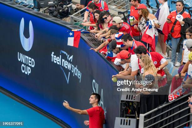 Tomas Barrios Vera of Team Chile takes selfies with fans after winning match point in the Group B doubles match against Maria Sakkari and Stefanos...