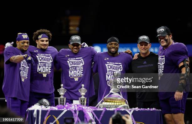 The Washington Huskies celebrate after a 37-31 victory against the Texas Longhorns in the CFP Semifinal Allstate Sugar Bowl at Caesars Superdome on...