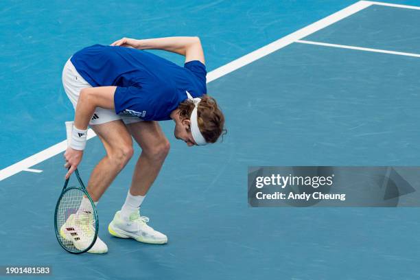 Stefanos Tsitsipas of Team Greece sustains a back injury as he competes with Maria Sakkari in the Group B doubles match against Tomas Barrios Vera...