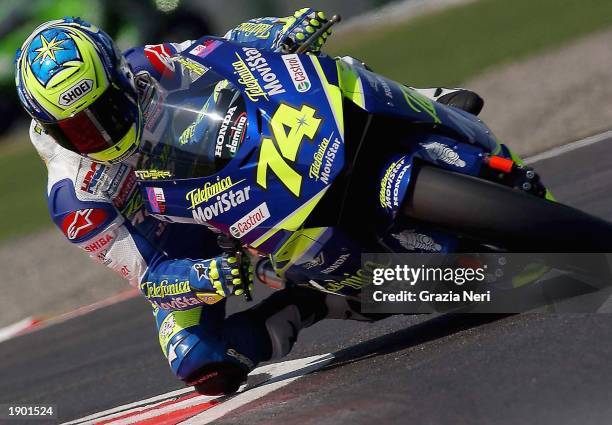 Dajiro Kato of Japan and the Telefonica Moviestar Honda team banks round a corner April 6, 2003 during Round 1 of the MotoGP World Championship at...