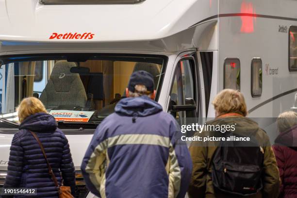 January 2024, Saxony-Anhalt, Magdeburg: Visitors to the "Tourisma und Caravaning Magdeburg" trade fair walk past a motorhome. Over 120 exhibitors...