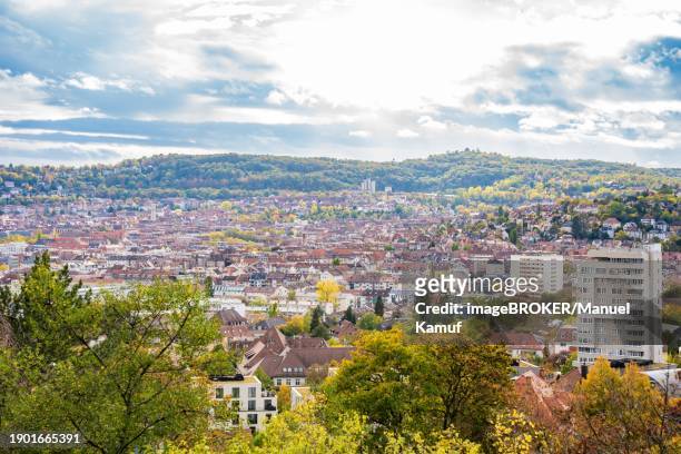 view of a city with dense buildings surrounded by autumnal trees under a cloudy sky skyline stuttgart, germany, europe - stuttgart skyline stock pictures, royalty-free photos & images