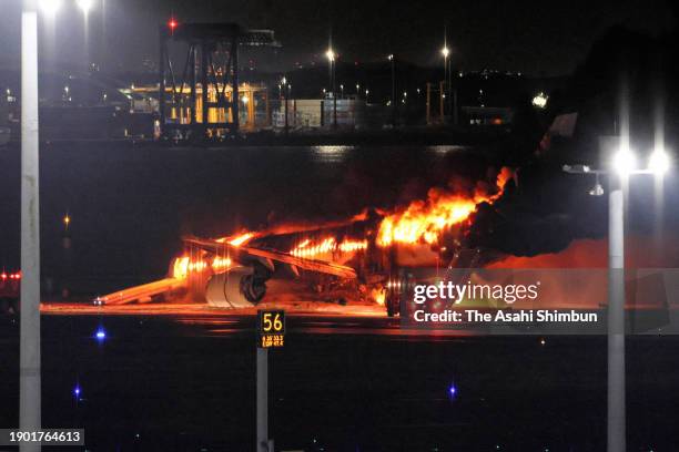 Japan Airlines 516 plane in flames at Haneda Airport on January 2, 2024 in Tokyo, Japan. The airplane collided with a Japan Coast Guard aircraft on...