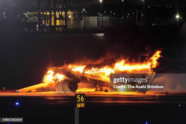 Japan Airlines Flight 516 plane in flames at Haneda Airport on January 2, 2024 in Tokyo, Japan. The airplane collided with a Japan Coast Guard...