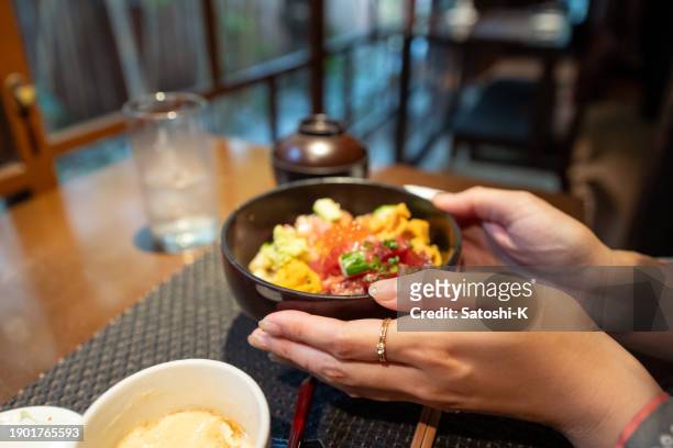 solo trip woman in kimono / hakama holding seafood donburi for lunch - chawanmushi stock pictures, royalty-free photos & images