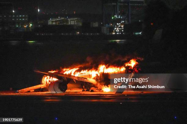 Japan Airlines Flight 516 plane in flames at Haneda Airport on January 2, 2024 in Tokyo, Japan. The airplane collided with a Japan Coast Guard...