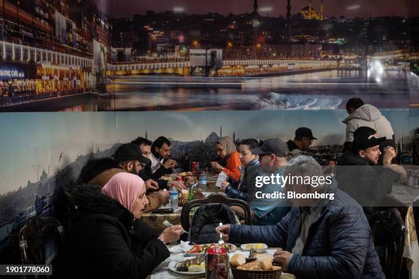 Customers dine at a restaurant inside a seafood market in Istanbul, Turkey, on Thursday, Jan. 4, 2024. The lira is headed for its biggest weekly loss...