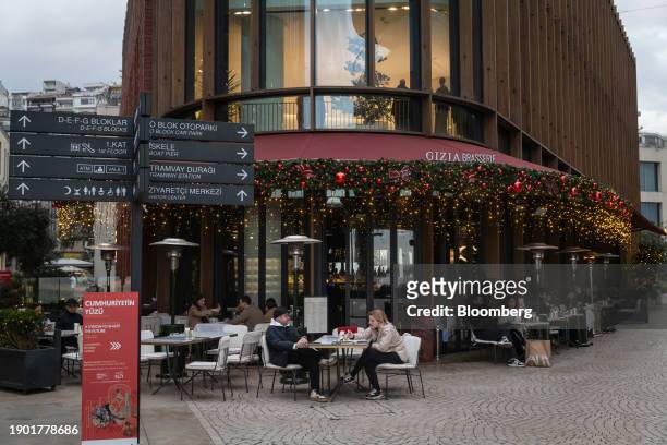 Customers dine at a brasserie terrace area at Galataport in the Karakoy district of Istanbul, Turkey, on Thursday, Jan. 4, 2024. The lira is headed...