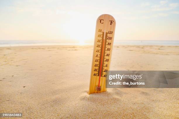 thermometer at beach - ondata di calore foto e immagini stock