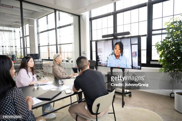 mature project manager communicating with team on video call - male creative director stock pictures, royalty-free photos & images