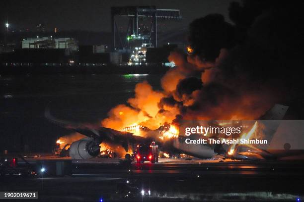 Japan Airlines 516 plane in flames at Haneda Airport on January 2, 2024 in Tokyo, Japan. The airplane collided with a Japan Coast Guard aircraft on...