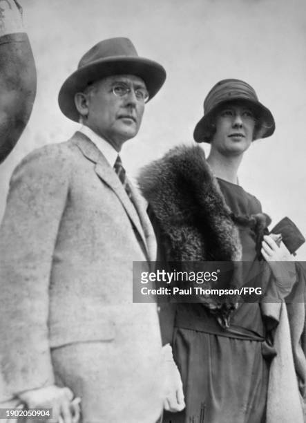 American publisher and businessman Conde Nast, wearing a light grey suit with a fedora, and American socialite Helen Huntington Astor, who wears a...