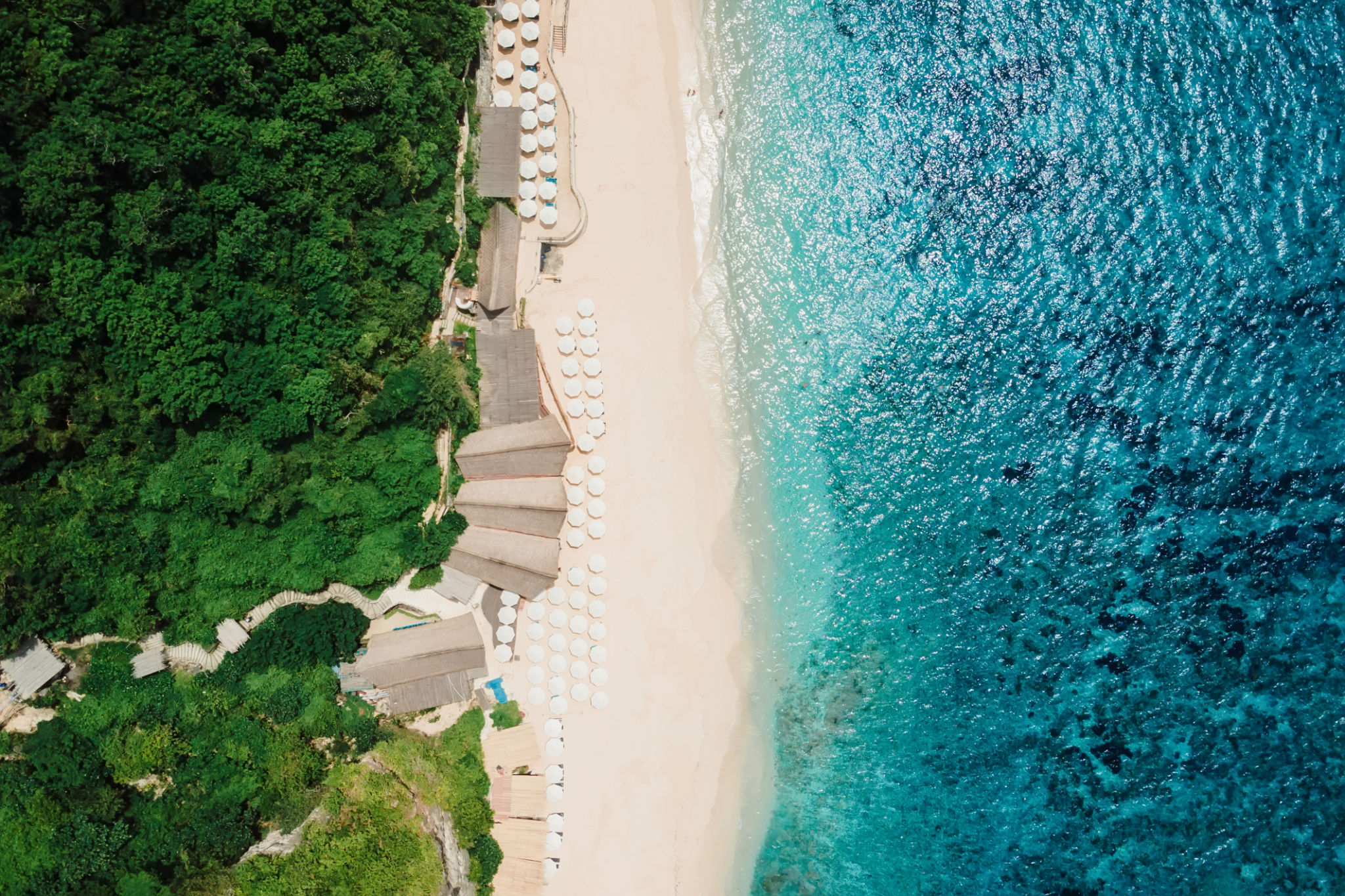 Paradise beach with turquoise ocean and luxury resort in Bali. Aerial view Paradise beach with turquoise ocean and luxury resort in Bali. Aerial view