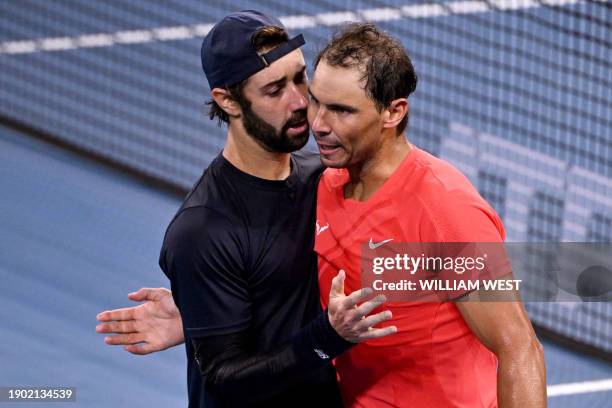 Australia's Jordan Thompson and Spain's Rafael Nadal gesture after the former's win at their men's singles match during the Brisbane International...