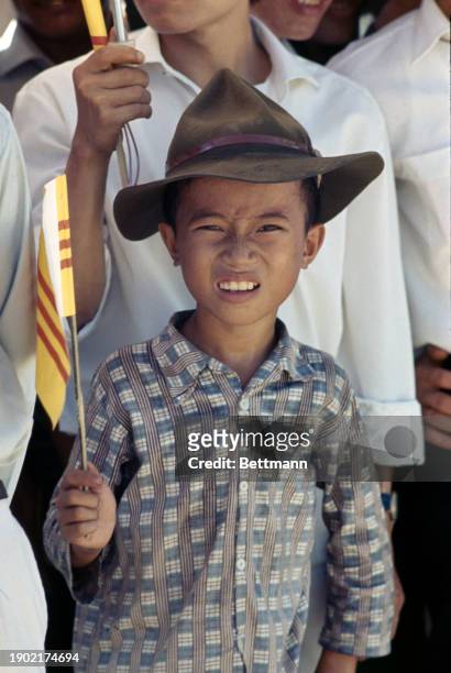 Boy holding a flag as he listens to a speech by Prime Minister Nguyen Cao Ky in Da Nang, South Vietnam, July 7th 1967.