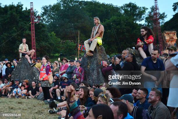 Spectators look on as performers take part in a peace ritual at the stone circle on Day 1 of Glastonbury Festival 2023 at Worthy Farm, Pilton on June...