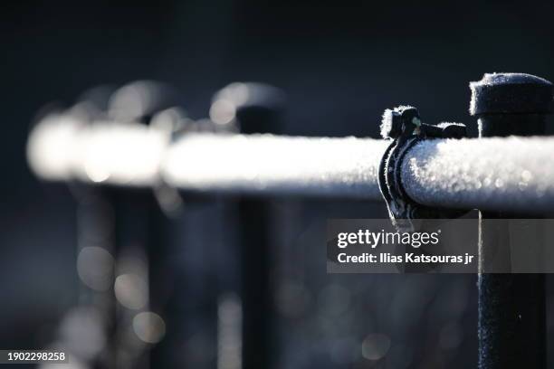 frost on pipe railing defocused background - frozen pipes stock pictures, royalty-free photos & images