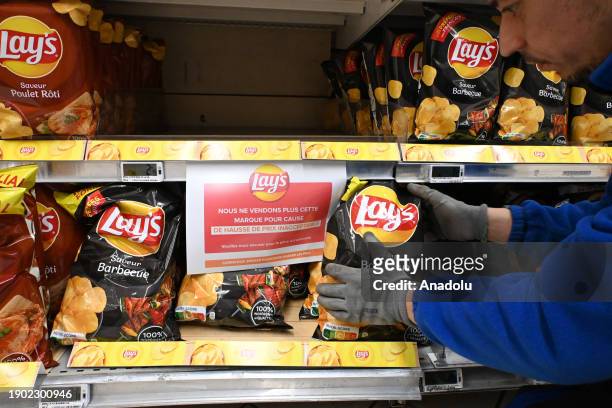 Grocery store clerk removes PepsiCo products from the shelves after the French multinational retail and wholesale company Carrefour has stopped...