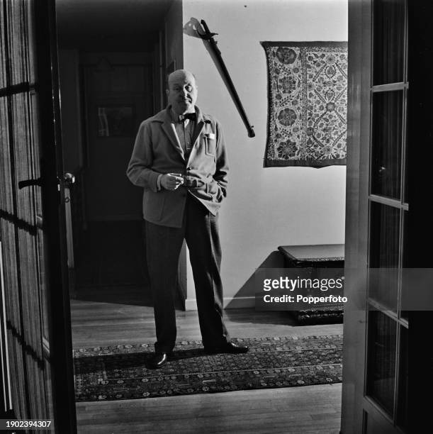 English author and crime fiction writer Peter Cheyney stands in the hallway of his apartment in London in September 1946.