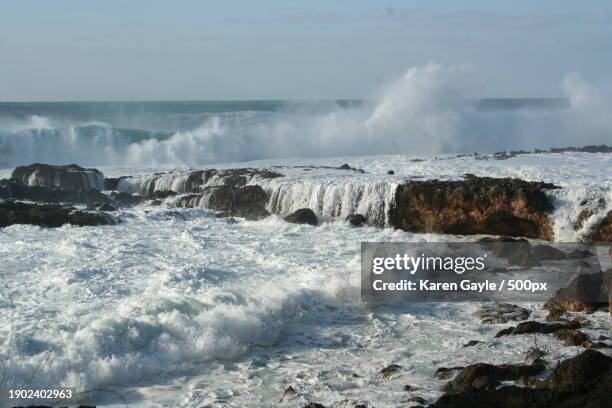 scenic view of waves splashing on rocks against sky,united states,usa - karen stock pictures, royalty-free photos & images