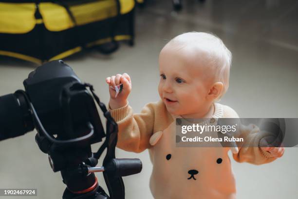 baby boy looking at camera on tripod. - yellow belt stock pictures, royalty-free photos & images