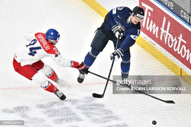 Czech Republic's forward Matyas Sapovaliv and Finland's defender Kalle Kangas vie for the puck during the bronze medal match between Czech Republic...