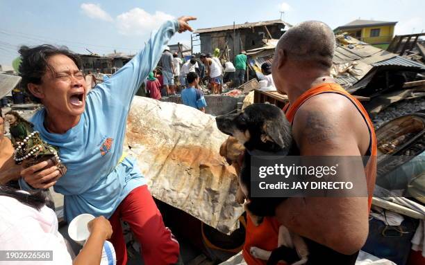 Woman cries as her house is demolished by workers of the Department of Public Work and Highways in Navotas City suburban Manila on March 4, 2010 as...