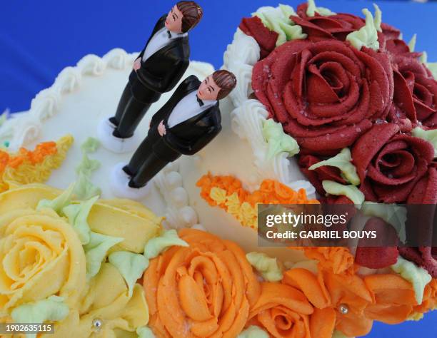 Wedding cake with statuettes of two men is seen during the demonstration in West Hollywood, California, May 15 after the decision by the California...