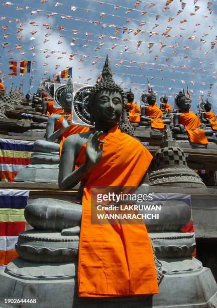 Buddha statue is decorated with robes at a temple in Colombo, 12 May 2006, during the holiest Buddhist festival of Wesak which marks the birth,...